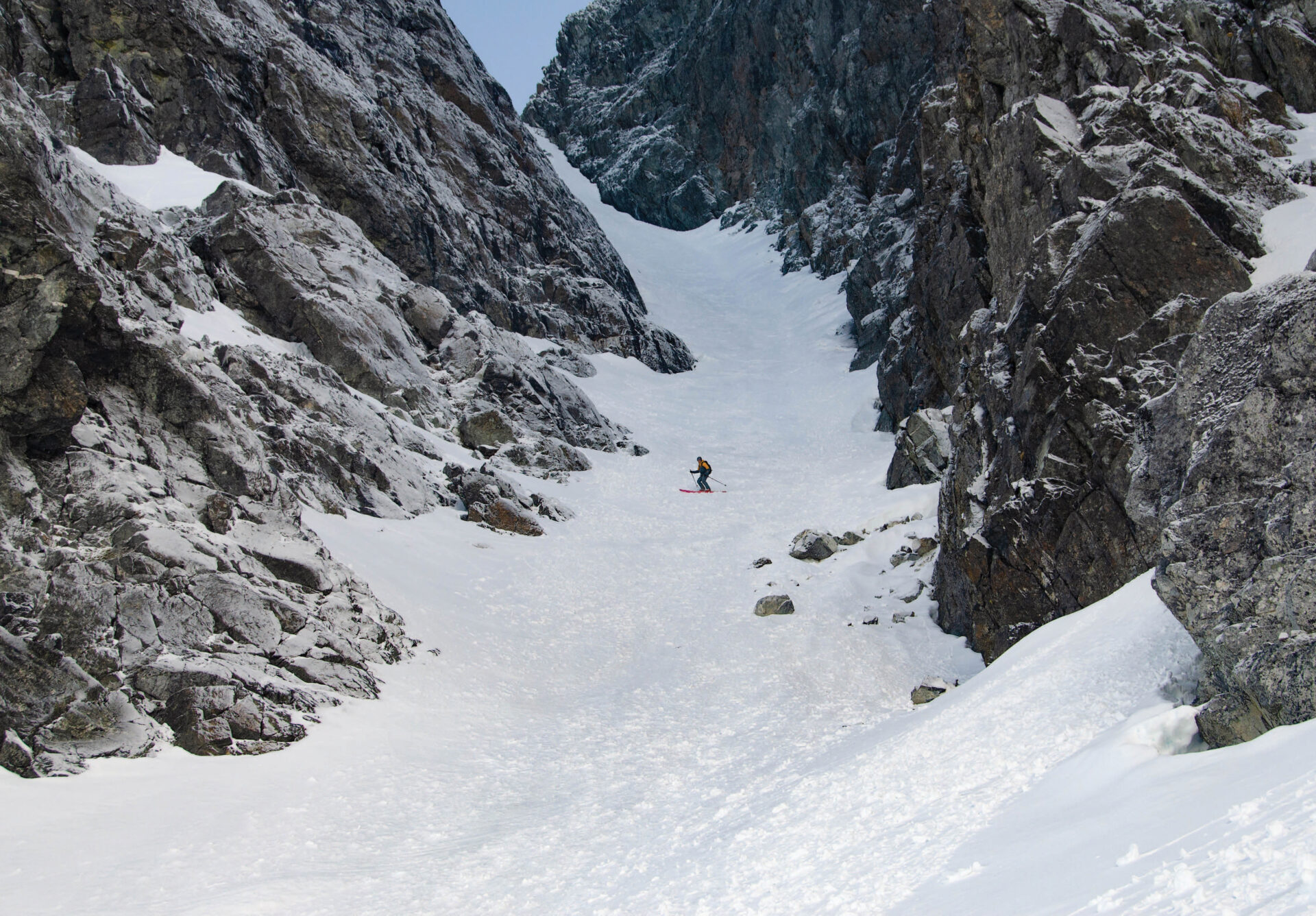 The basalt walls of Colonel Foster are frosted with fresh snow as Joe Schwartz nears the bottom of the Great West Couloir.