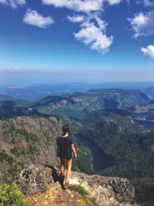 Photo of women standing on mountain peak