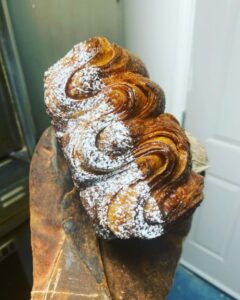 Photo of freshly baked pastry with sugar powder