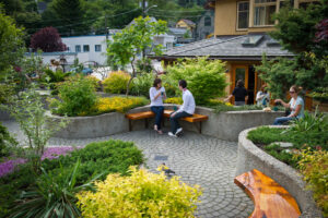 People sitting on a bench in a garden Nelson British Columbia